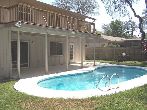 Pool w view of deck and back