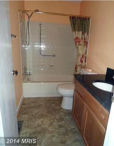 Full bath with granite topped vanity