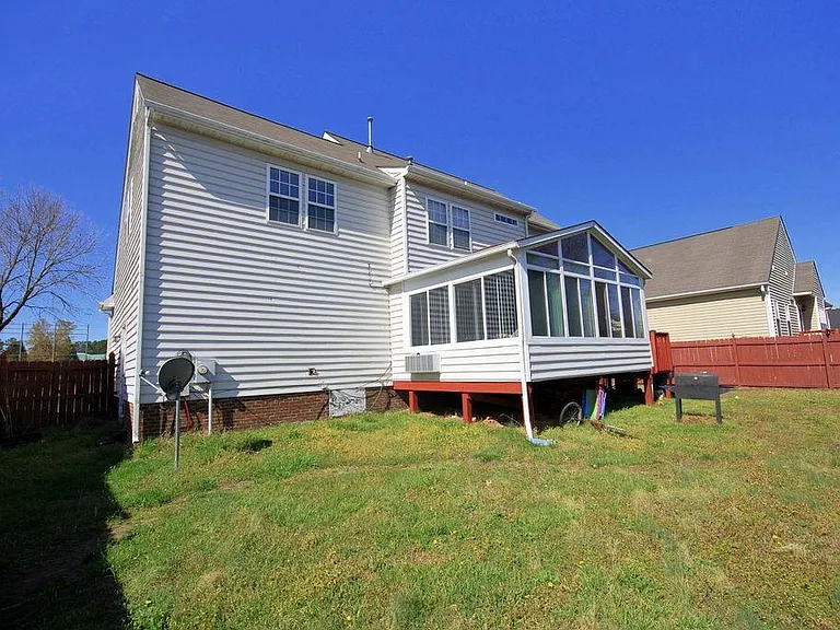 This spacious, private backyard can be easily viewed from the sunroom, offering a peaceful and scenic extension of the indoor living space.