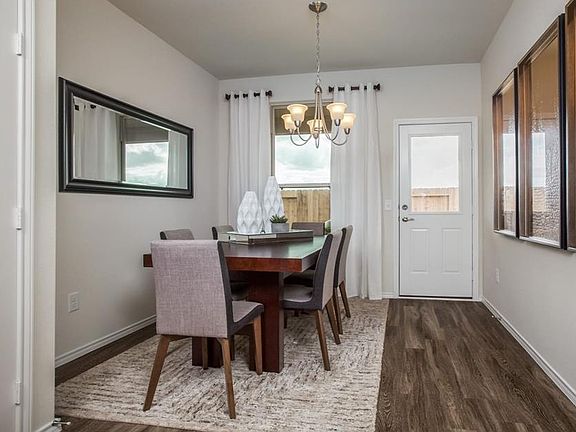 Dining Area. (Photo shown is a builder's reference image of the same floor plan. Image includes furniture and finishes not included in the rental.)