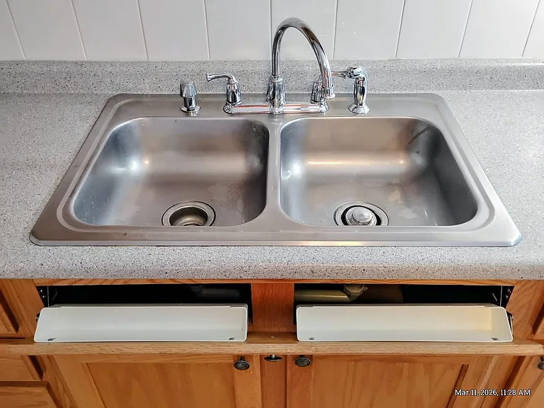 Double Sink with sprayer.
Upper door pulls open for more storage.
