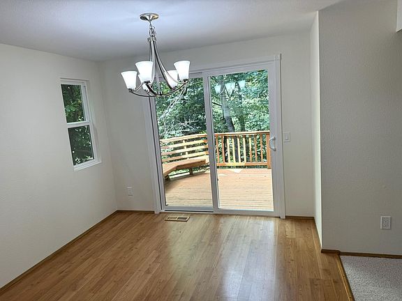 Dining area looks at small deck and backyard/ravine backing property