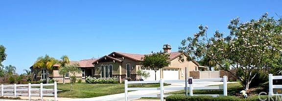 Front Elevation side view showing the ranch style with 4 car garage and RV gate