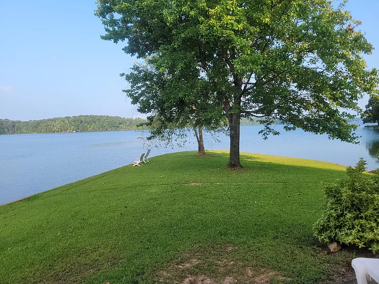 Dock is on the left of the point and sandy beach is on the right.....200+ ft. of lakeshore, close to Goat Island and dam. Dock has new surface - not wooden.