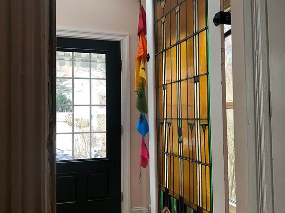 The entrance into the sunroom, with skylights, radiant heat flooring, and an amazing piece of stained glass.