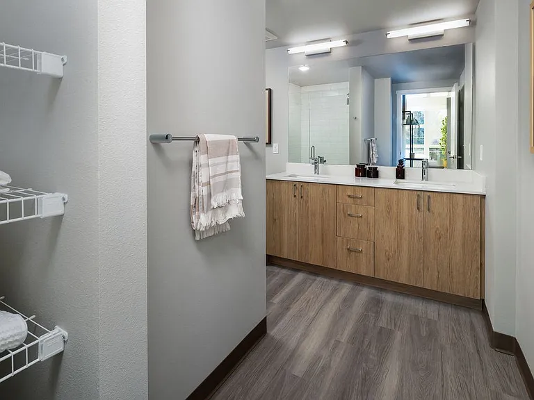 Bathroom with oak cabinetry and white granite countertops