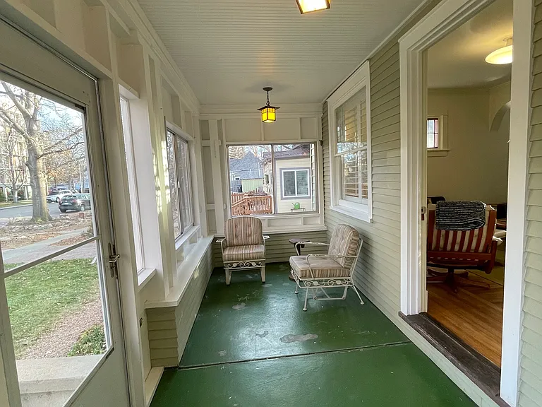 Cozy enclosed front porch.
