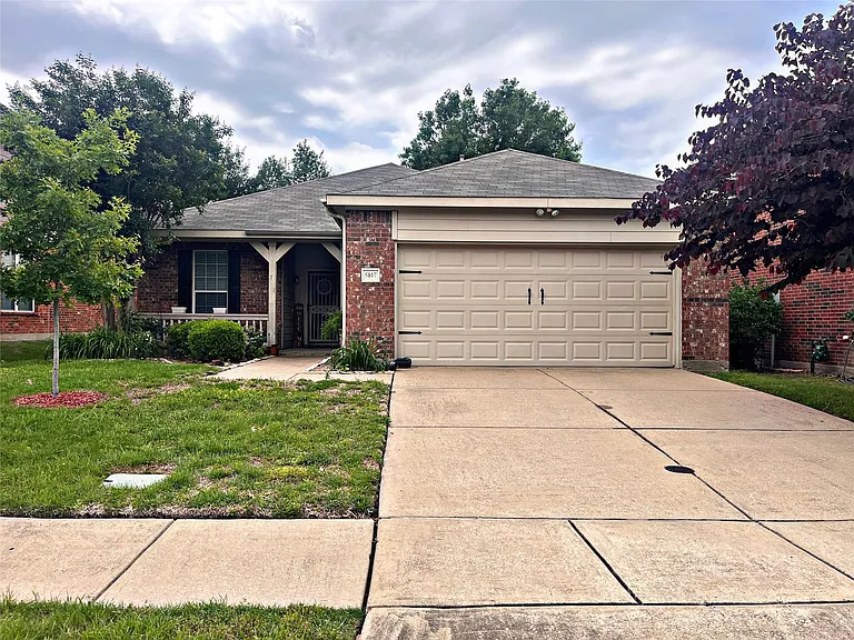 Single story home with a front lawn and a garage