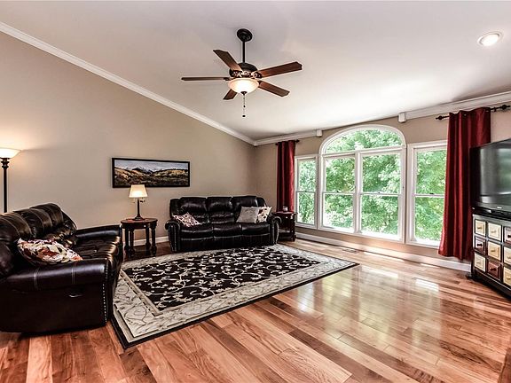 Vaulted great room with view to back yard, hardwood flooring, crown molding.