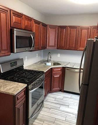 Kitchen with Cherry Cabinets, granite countertop and dishwasher