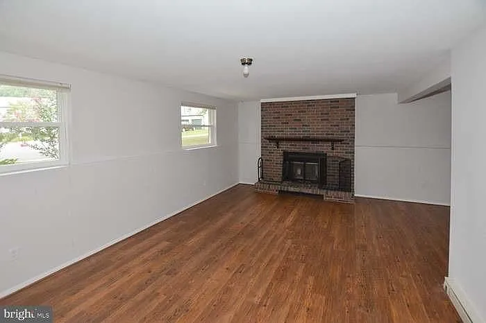 Spacious 2nd living room/ family room combo with wood burning fireplace. (Lower level).