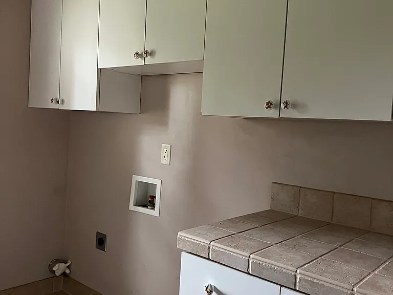 Laundry hook ups with cupboards