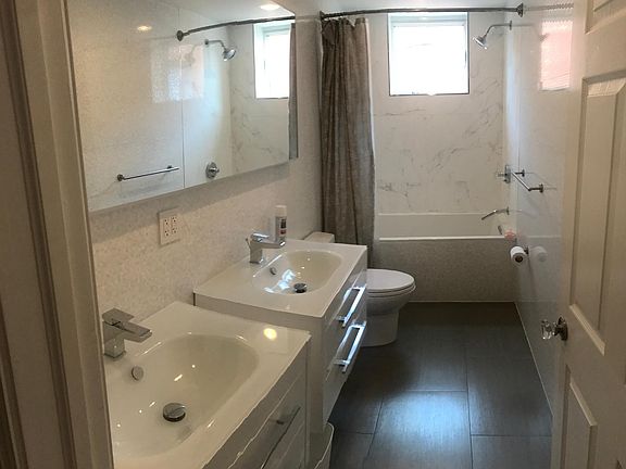 Modern, bright 2nd bathroom with 2 sinks, NOT ENSUITE. Hallway access.