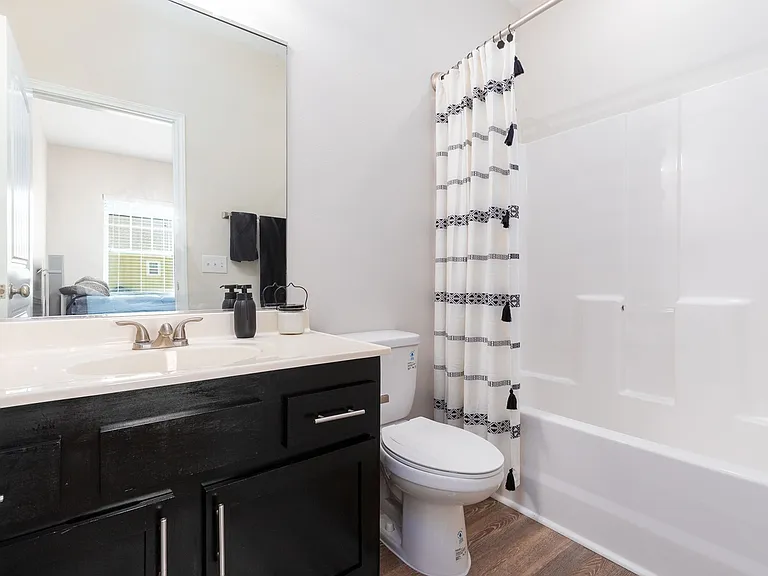 Refresh in a Modern Bathroom with Sleek Dark Vanity at Seaglass Apartments - Luxury Corpus Christi Living
