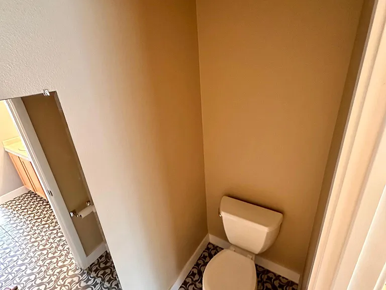 Master bathroom with two sinks, shower, and toilet
