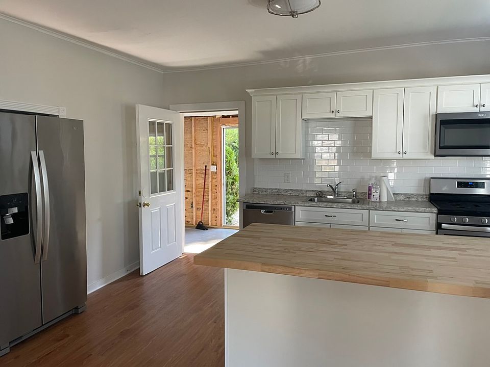 Kitchen with view towards 6th Ave entrance and enclosed porch (to be completed before move-in)