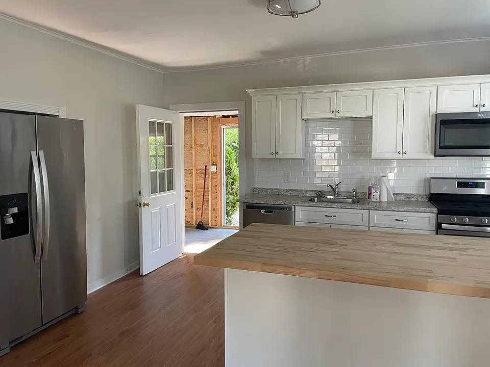 Kitchen with view towards 6th Ave entrance and enclosed porch (to be completed before move-in)