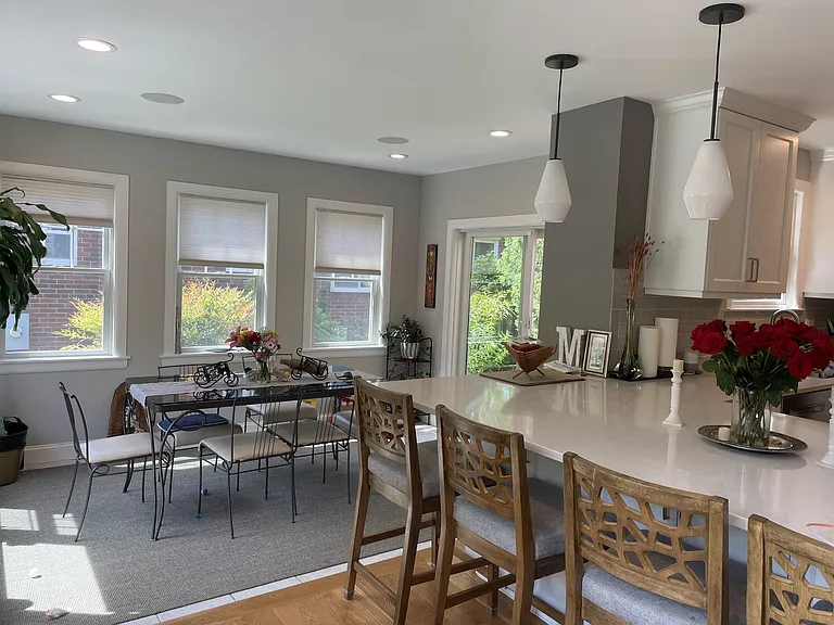 The dining room (sun room). Custom-designed, wrought-iron glass top table and matching chairs provided.
