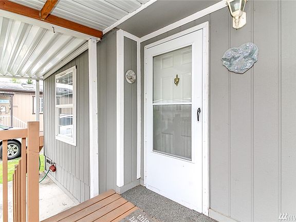 Invites you in right from the covered carport onto the covered front porch.