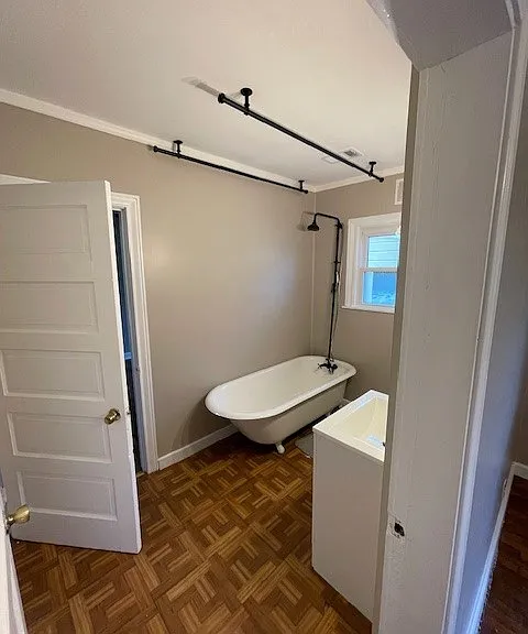 freshly finished clawfoot tub and new vanity installed