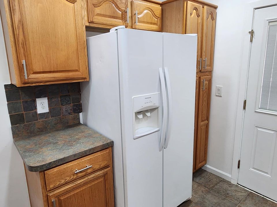 Side by side refrigerator with water and ice on the door.