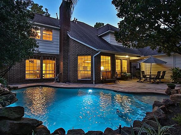 OASIS AT NIGHT: Imagine this relaxing spot in your own backyard for an evening swim or dinner on the patio to the sound of the rock waterfall.