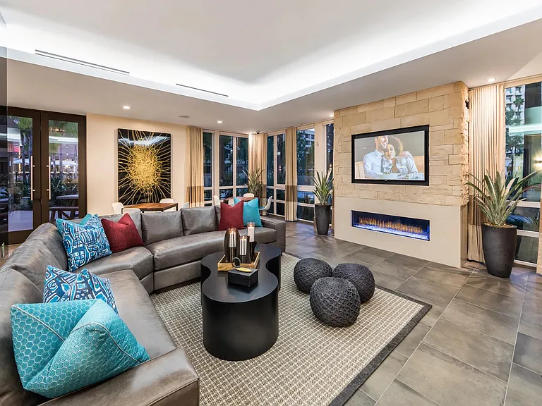 Lounge with fireplace and TVs offering a warm setting for gatherings.