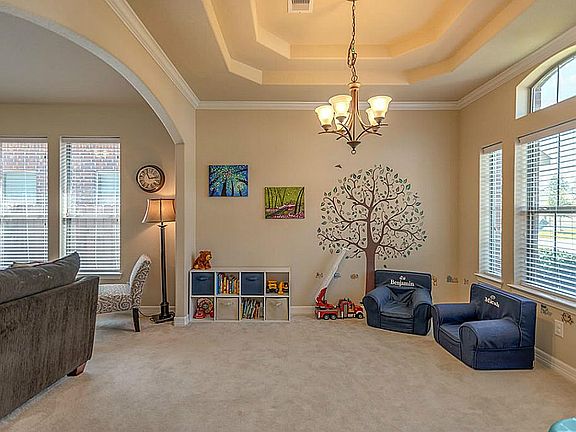 Formal dining room with elegant trayed ceiling.