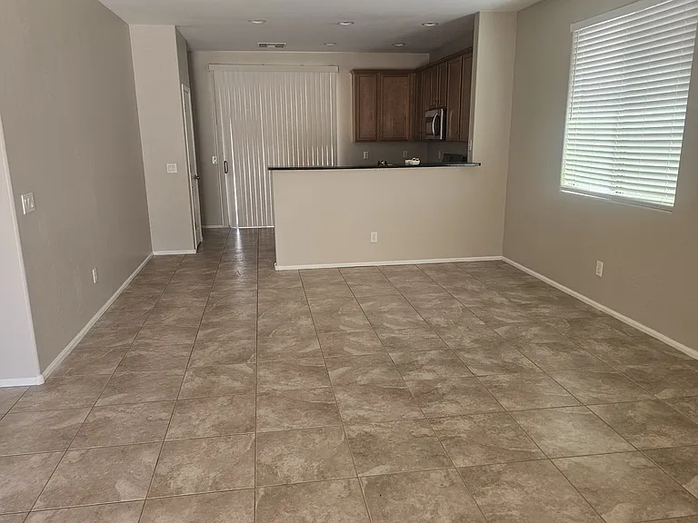 Main Living area to Kitchen in back next to slider for access to back yard
