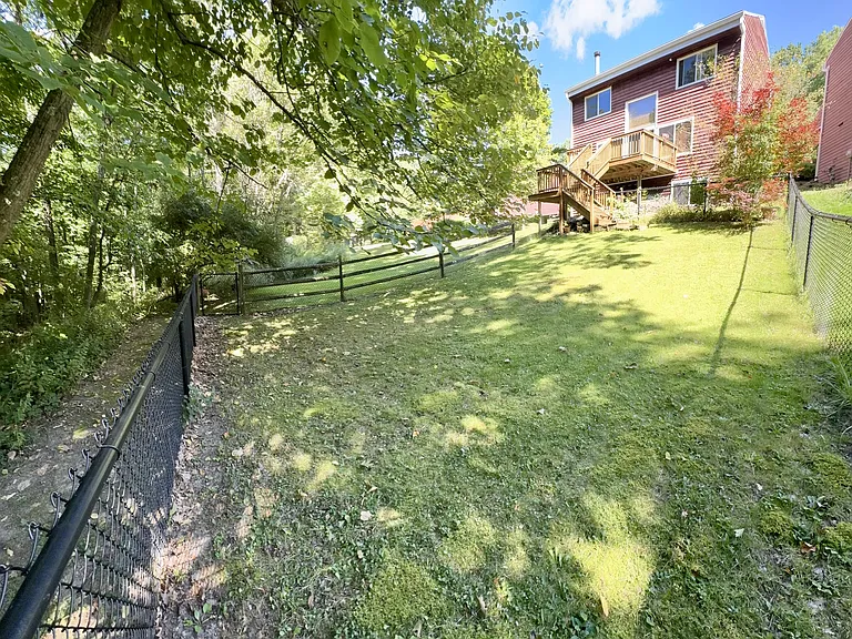Fenced in yard with gate to walking path through the woods to Second Dam