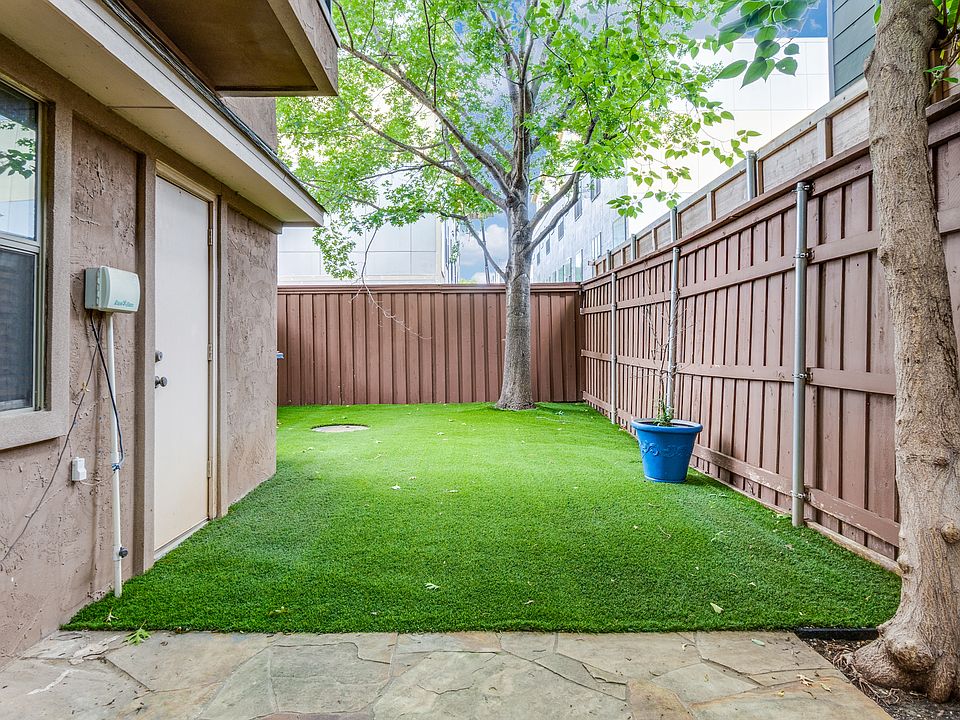 Huge private yard and patio with a flex space and half bath on the first floor, perfect for entertaining outside!