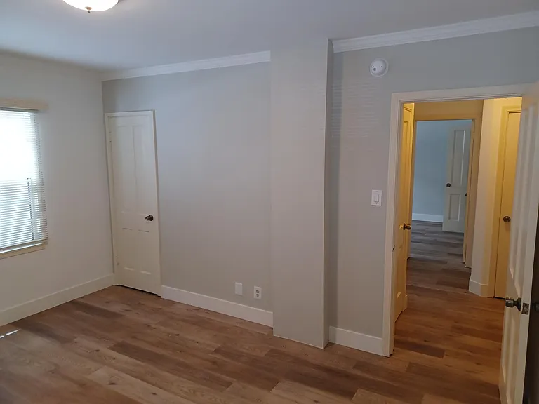 Left side bdrm showing entry door, closet, north windows.