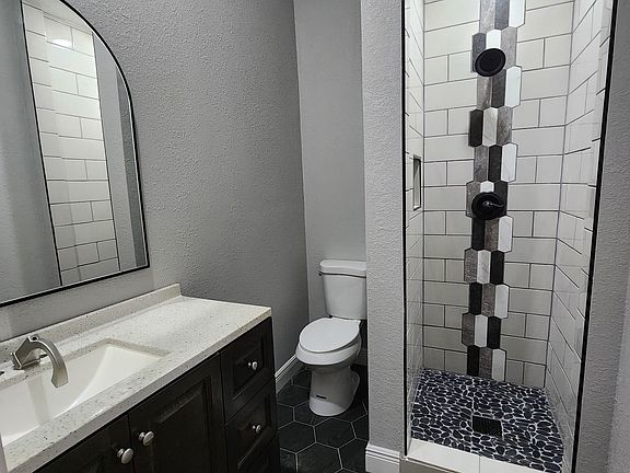 Bathroom in middle Bedroom. 
Quartz countertops and Tile floor