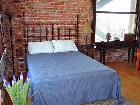 A large bedroom area is separated from the main living space, with a private closet, W/D and en-suite full bath.