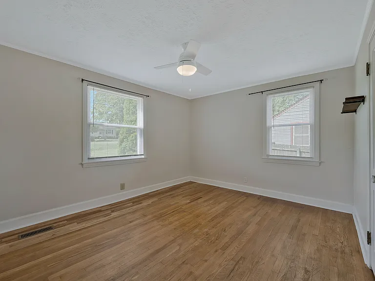 Photo 15. Master bedroom with windows and ceiling fan