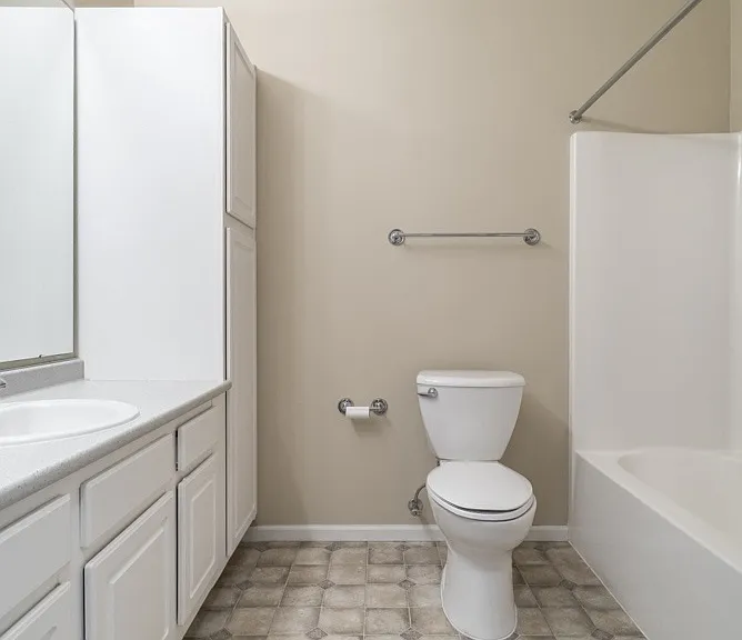 Enjoy a spacious, clean-lined bathroom with plenty of built-in storage and a combination shower and tub.