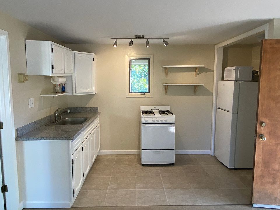 Efficient kitchen area with gas stove, microwave, refrigerator, dishwasher