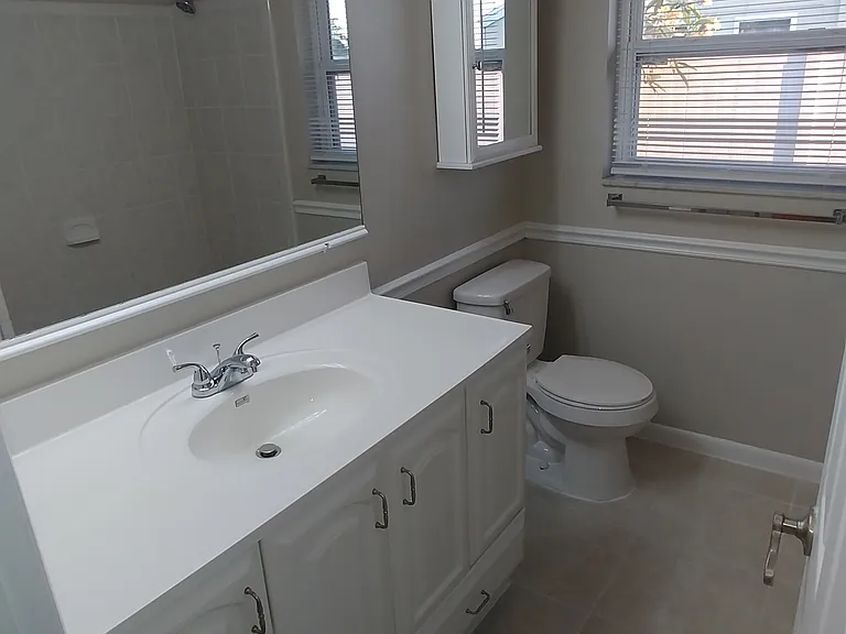 Guest bath with linen closet.
