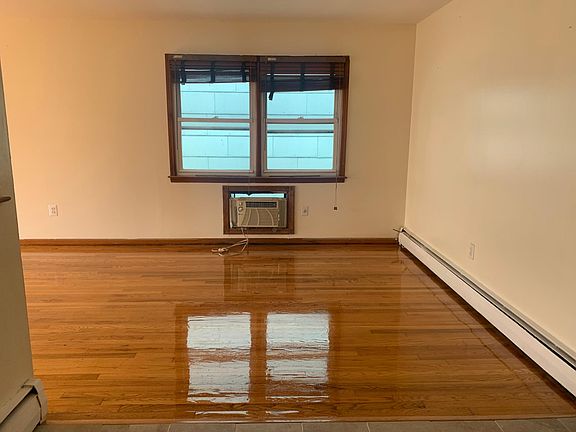the living room with the side windows and designated space for personal air conditioner
