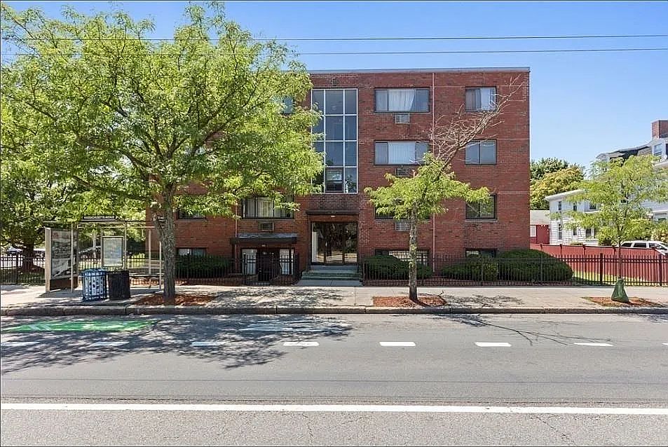 Outside. Front door opens to bus stop in Mass Ave. Parking behind the building. Assigned parking spot for the tenant at no extra cost.
