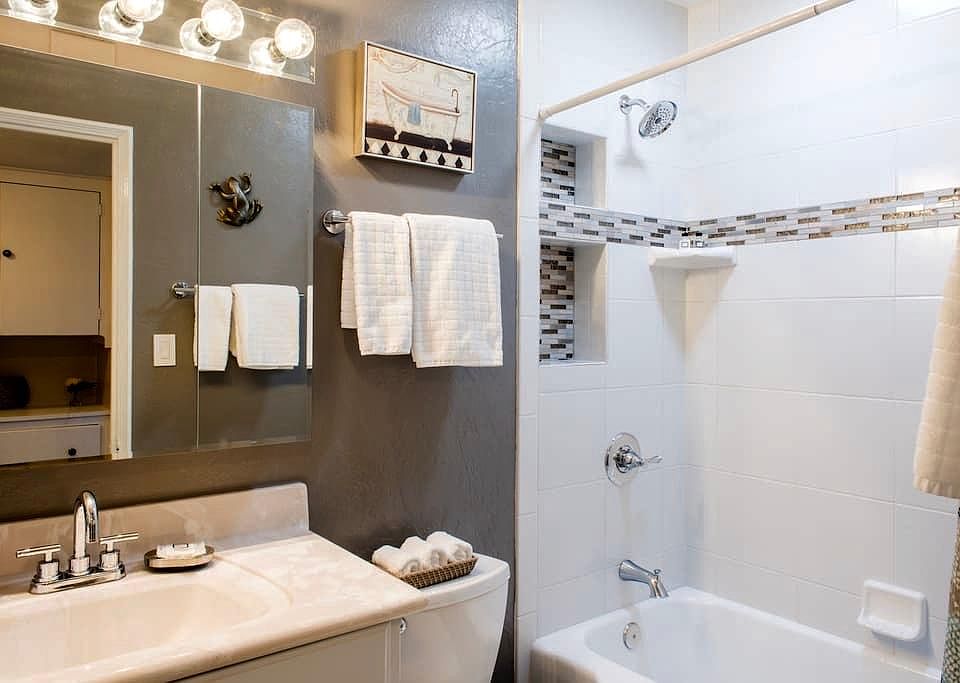 Since photo taken the sink, counter top and faucet new. All plumbing updated and new. Another photo shows new counter, sink and faucet. Bathroom has solar tube skylight.