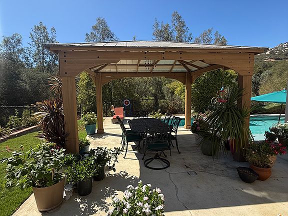 New wooden gazebo in large fenced back yard. I'm a "floweraholic". Don't worry I will take all those pots so you don't have a huge amount of gardening :-)