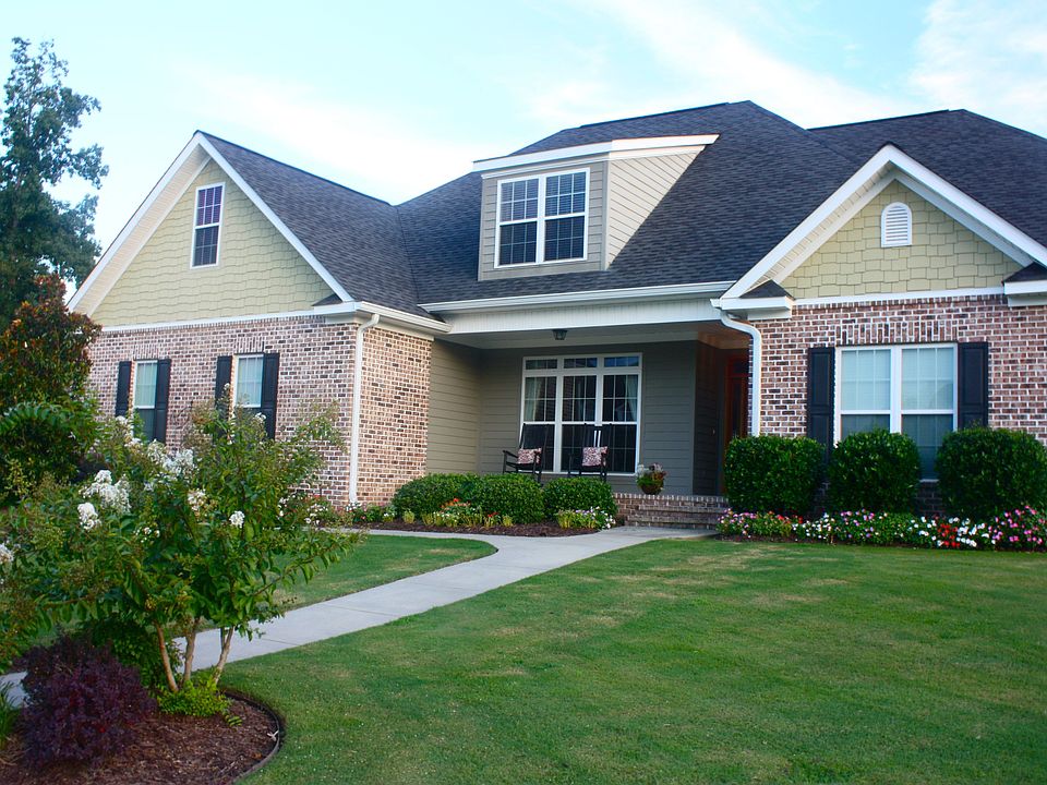 Lush landscaping in front and back yard