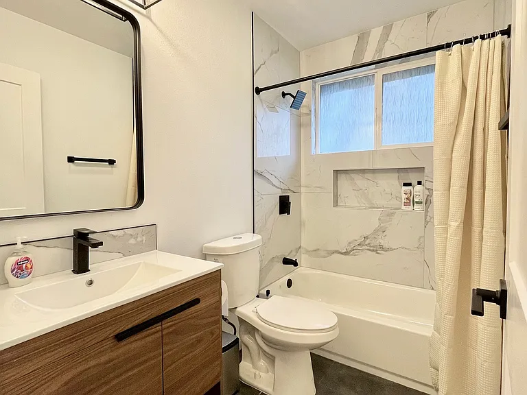 Bath or shower, your choice: Experience the ultimate relaxation in our bathroom with both a bathtub and a sleek shower.
