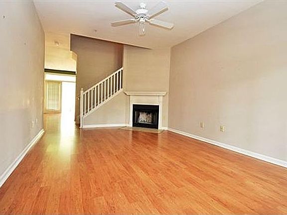 Living room with fan and fireplace