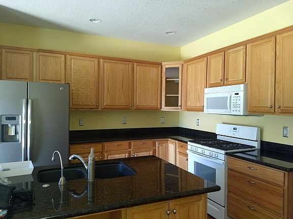 Kitchen with granite counter tops and hard wood flooring. Comes with all kitchen appliances.