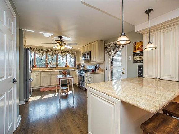 The light, and bright kitchen offers storage and work space galore! The door on the left opens to the pantry, and bonus cabinet 