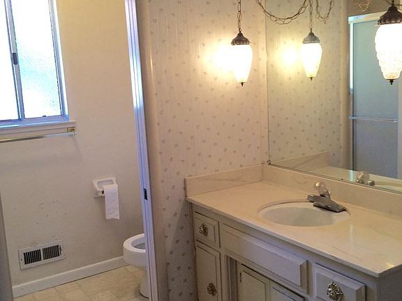full bathroom and mirror closet behind the dresser.