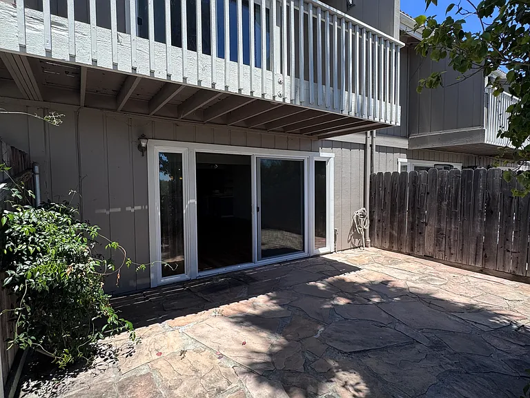 Large flagstone patio with private balcony above.