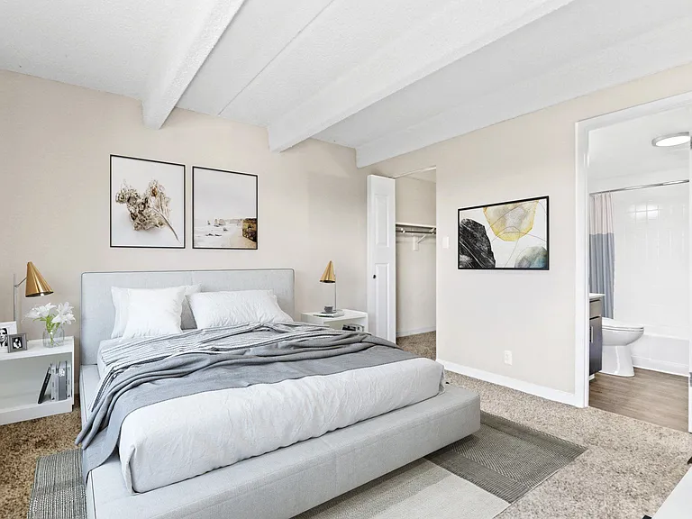 Bright and inviting bedroom with exposed beam ceiling and soft neutral palette